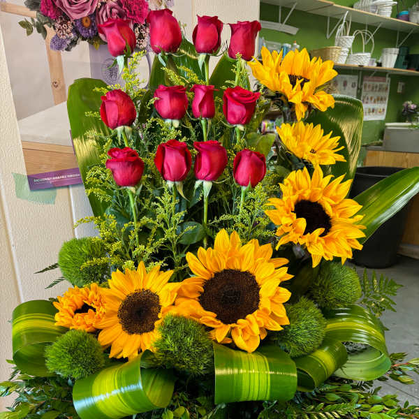 Tall floral arrangement with red roses and yellow sunflowers