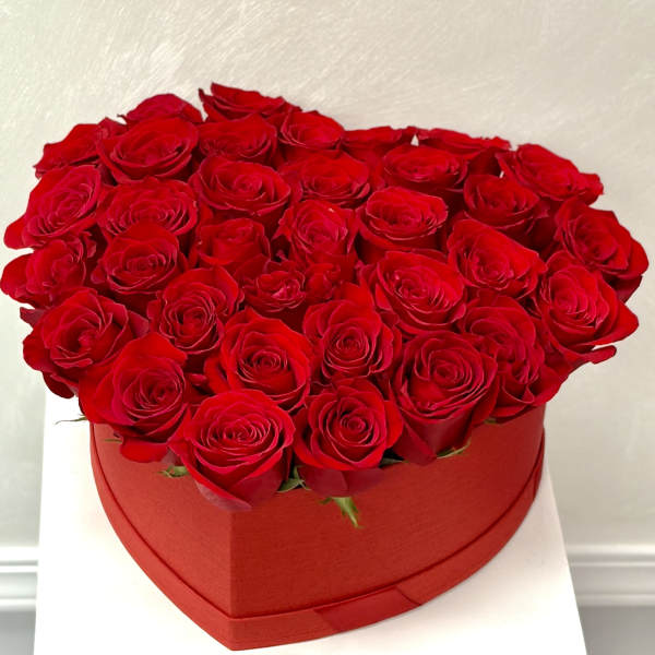 Heart-shaped box filled with red roses
