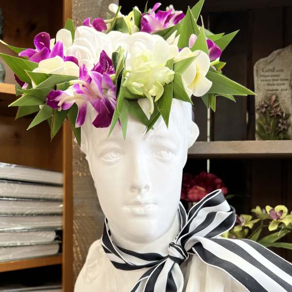 Floral crown of white and purple orchids on a white bust