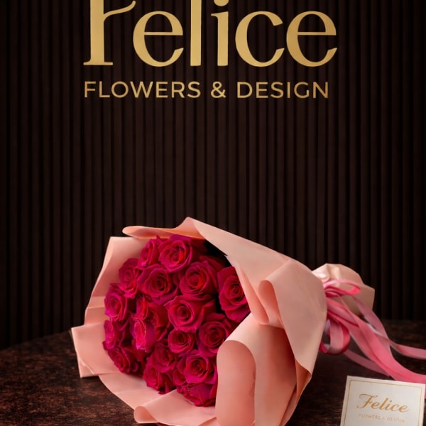 Bouquet of hot pink roses wrapped in pale pink paper