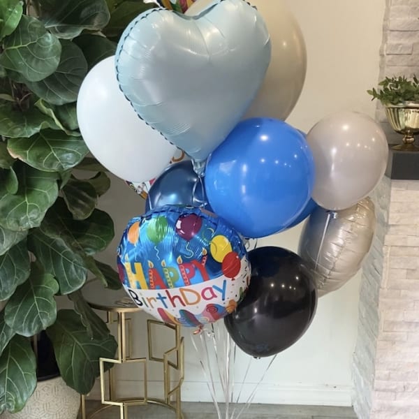 Birthday balloon bouquet with a teddy bear and chocolates
