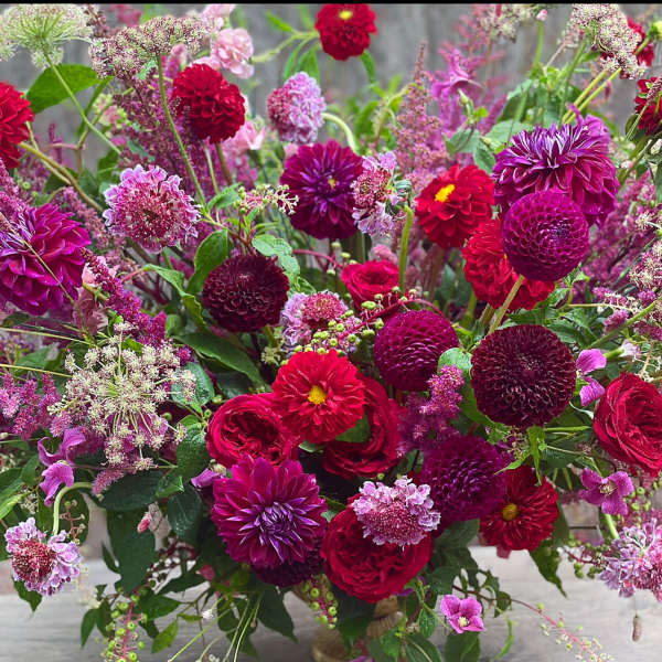 Large bouquet of magenta, red, and pink flowers