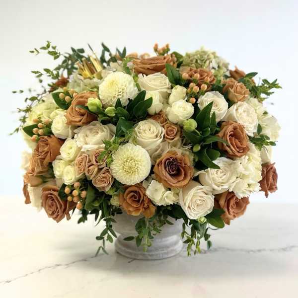 Cream and tan rose bouquet in a white vase