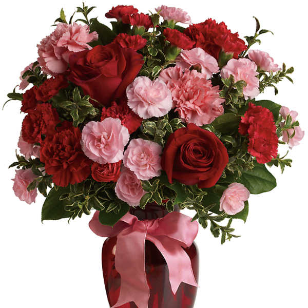 Red roses and pink carnations in a red vase with a pink ribbon