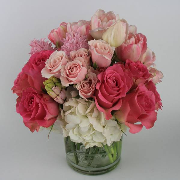 Pink and white rose bouquet in a glass vase