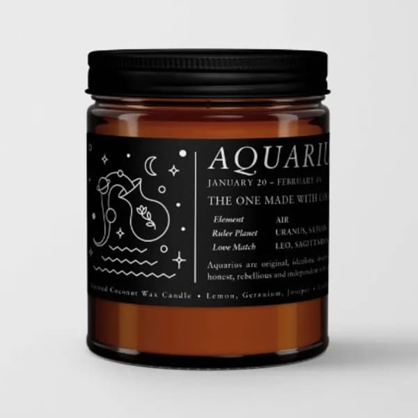 Amber candle in a black-lidded jar with an Aquarius label