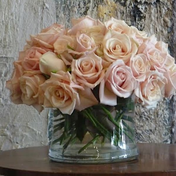 Bouquet of pale pink roses in a clear glass vase