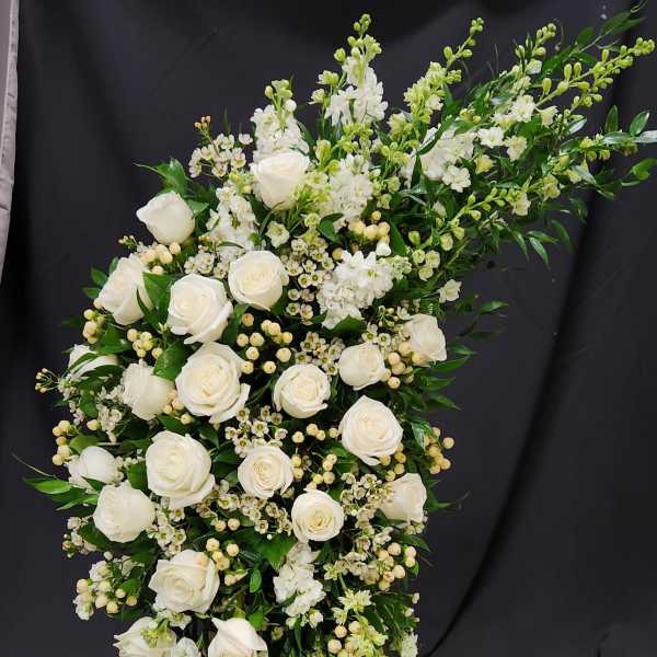 White rose standing spray on a wooden easel