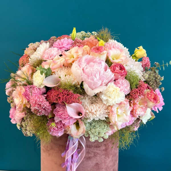 Large pink and peach mixed flower arrangement in a velvet hat box