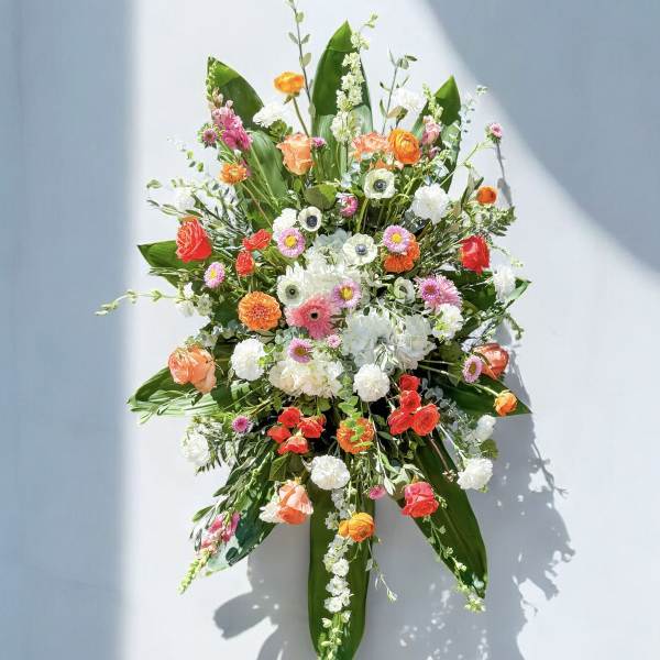 Large floral spray with orange, pink, and white blooms