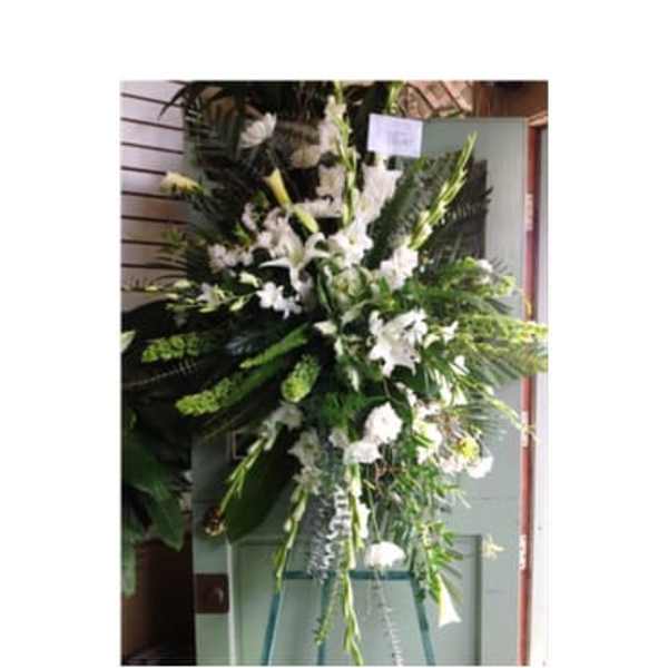 Tall white floral standing spray on an easel