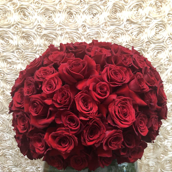 Large bouquet of red roses in a glass vase