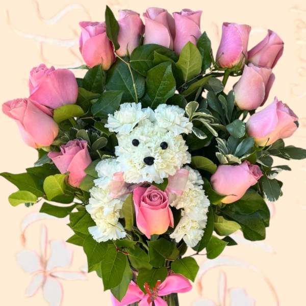Pink roses and a white teddy bear made of carnations in a glass vase