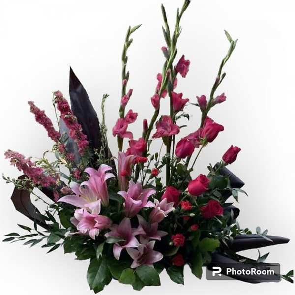 Pink lilies and roses in a tall mixed bouquet