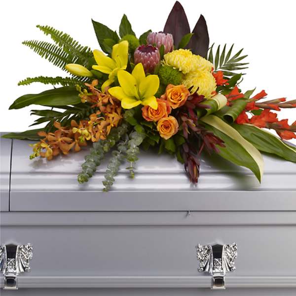 Colorful floral spray on a silver casket
