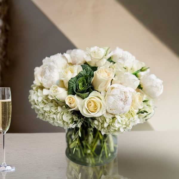 White rose and hydrangea arrangement in a glass vase