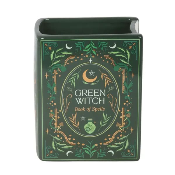 Green witch spell book-shaped ceramic container with decorative botanical artwork