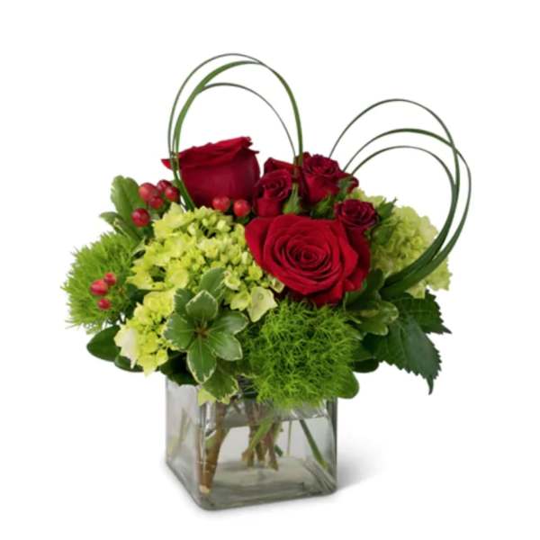 Red roses and green hydrangeas in a square glass vase