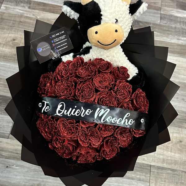 Red glitter rose bouquet with a plush cow and a black ribbon banner