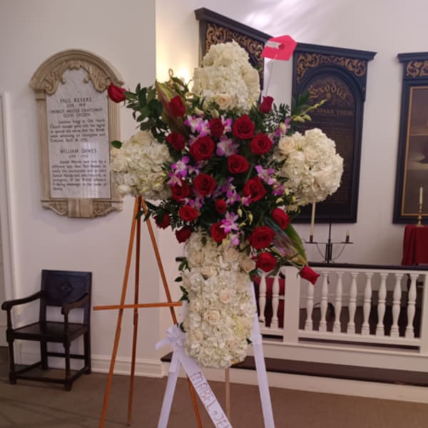 Large standing funeral spray with red roses and white hydrangeas