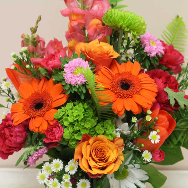 Bright mixed bouquet with orange gerbera daisies and roses