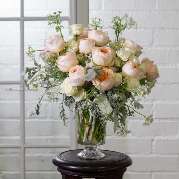 Blush and cream roses in a clear glass vase