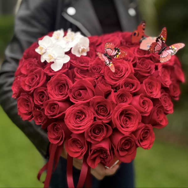 Heart-shaped bouquet of red roses with white orchids and butterfly picks