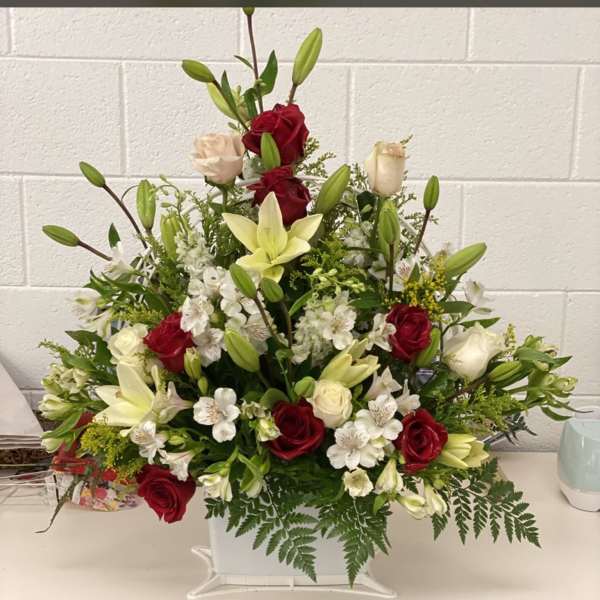 Red and white floral basket with lilies and roses