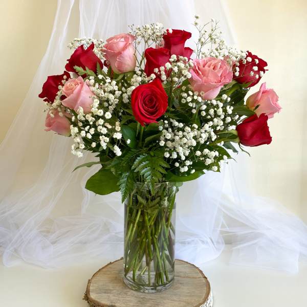 Bouquet of red and pink roses in a clear glass vase