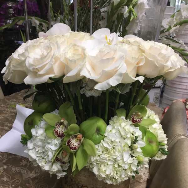 White rose and orchid arrangement in a birch-style container