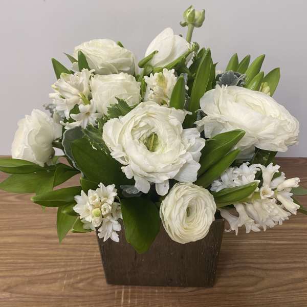 White flowers arranged in a dark rectangular container