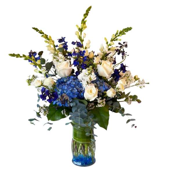 Blue and white floral arrangement in a glass vase