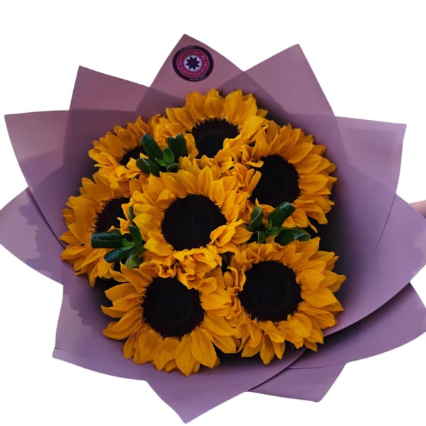 Bouquet of sunflowers wrapped in purple paper