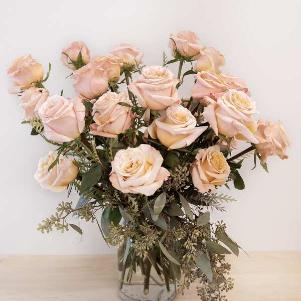 Blush peach rose bouquet in a clear glass vase