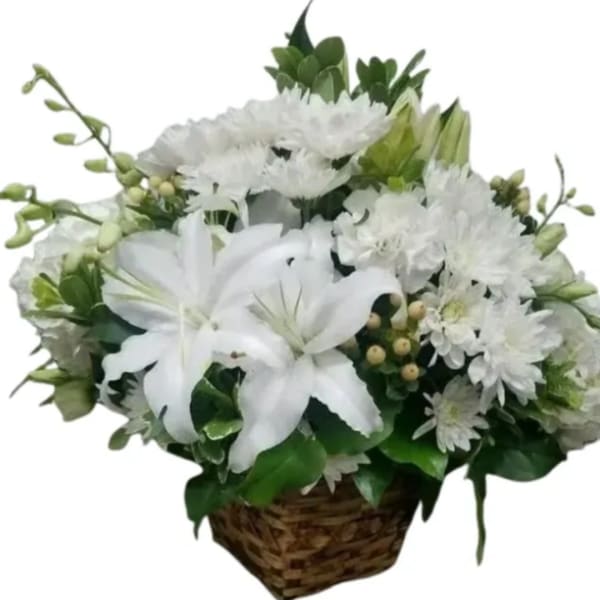 White lilies and chrysanthemums in a woven basket