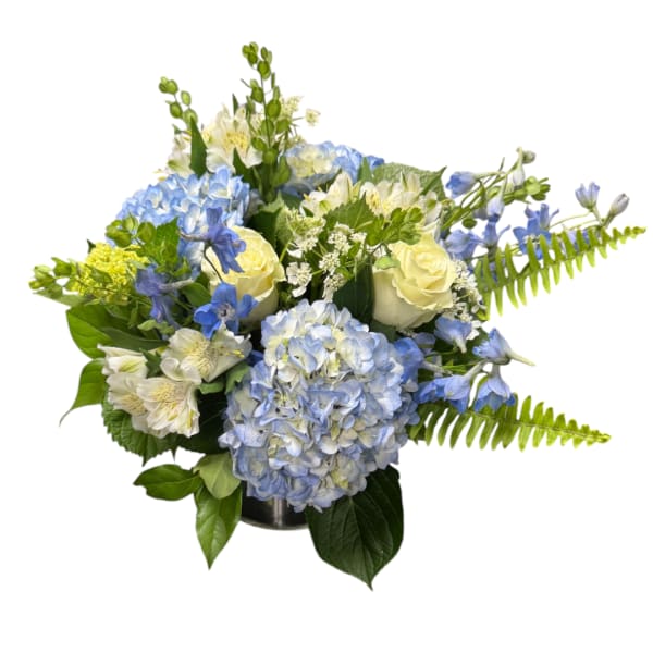 Blue hydrangeas and white roses arranged in a vase with greenery