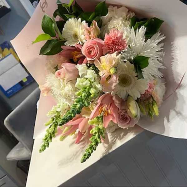 Pink and white mixed bouquet wrapped in pale paper