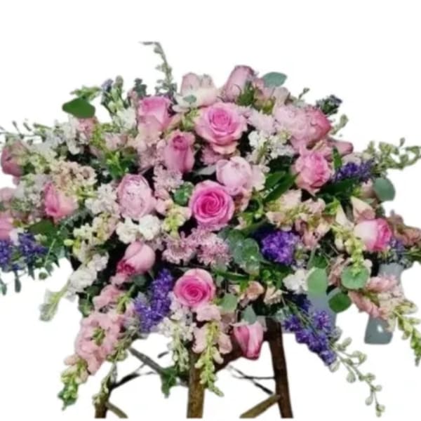 Large pink and purple mixed flower arrangement on a stand