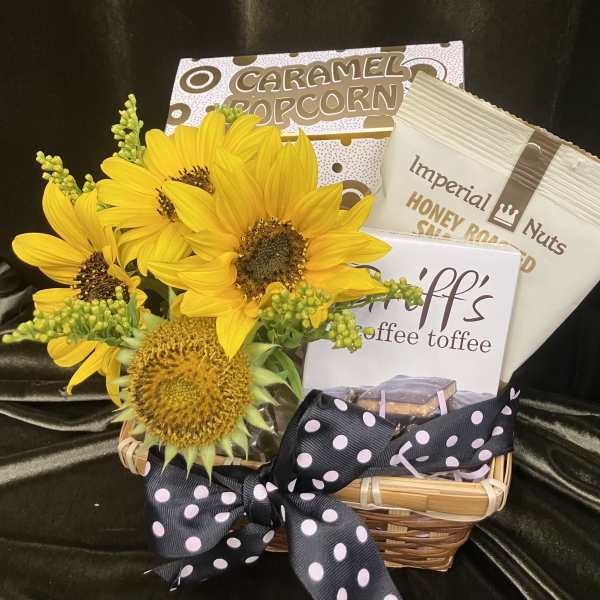 Sunflowers in a basket with caramel popcorn, nuts, and coffee toffee.
