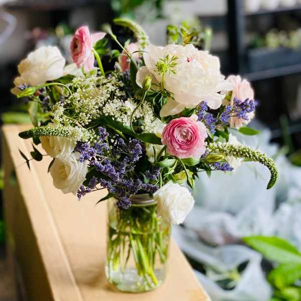 Mixed bouquet of pink and white flowers in a glass vase