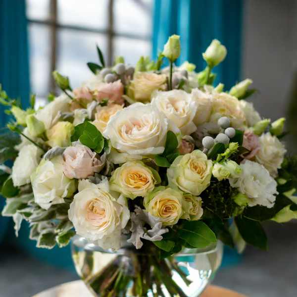 Cream and blush roses arranged in a clear glass vase