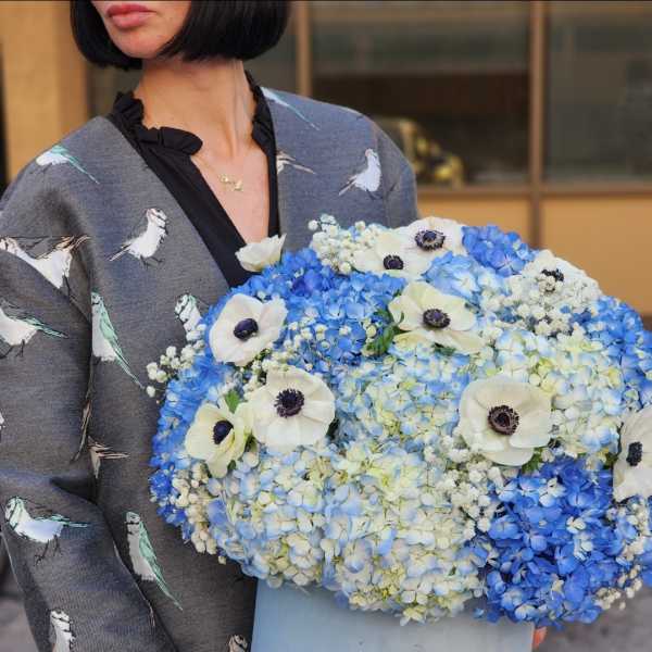 Blue and white hydrangea bouquet with white anemones in a pale blue box