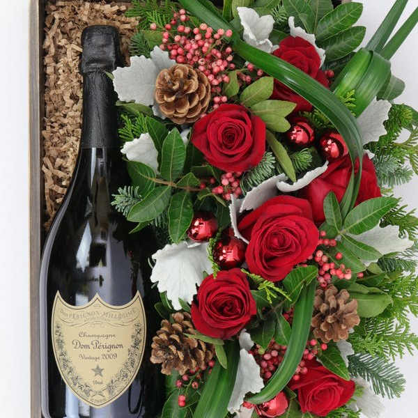 Gift box with a champagne bottle and red rose arrangement