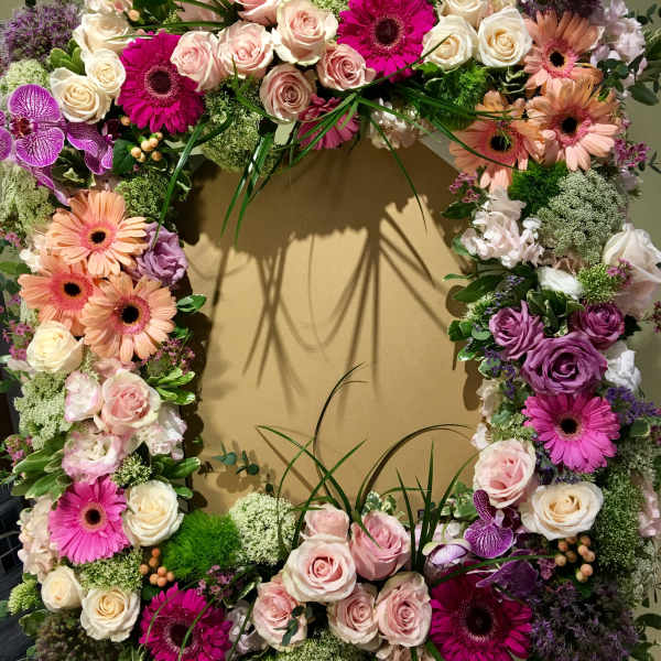 Large floral wreath with pink, white, and purple blooms