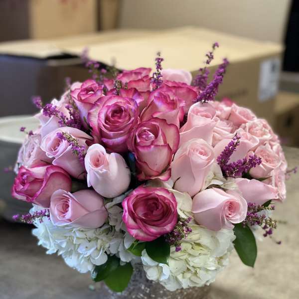 Pink and white rose bouquet in a silver vase