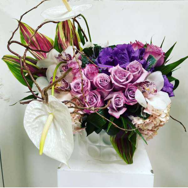 Bouquet of lavender roses, white anthuriums, and purple flowers
