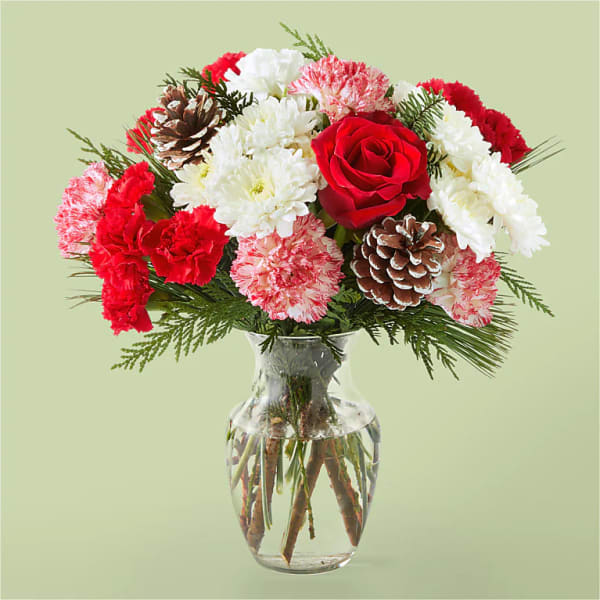 Bouquet of red and white flowers in a clear glass vase