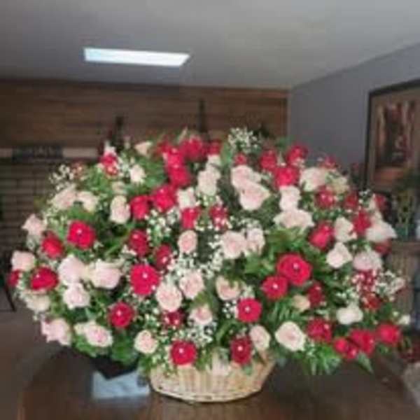Large basket arrangement of red and pale pink roses