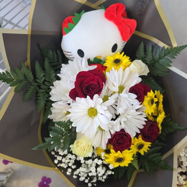 Bouquet with a Hello Kitty plush and red, white, and yellow flowers
