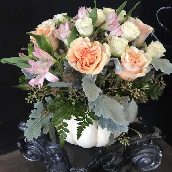 Peach and white roses with pink alstroemeria in a white pumpkin container